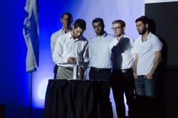 Students from YU's Soldiers in Exile Club light a memorial candle at the Yom HaZikaron tekes.
